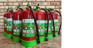 9kg lithium-ion fire extinguishers on a wooden table with a brick background